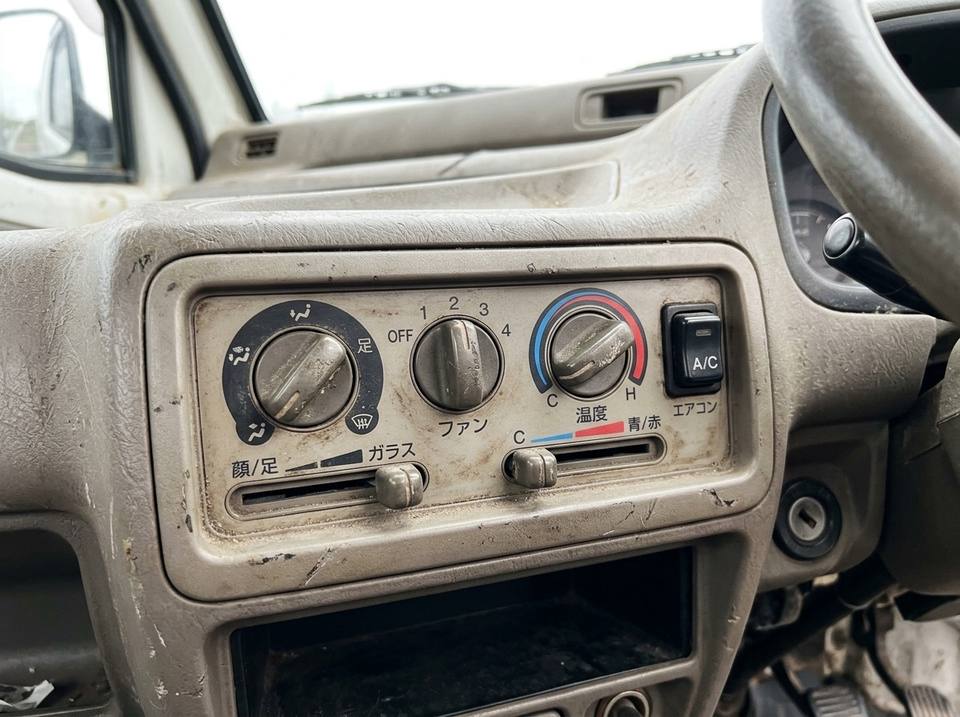 Heater and A/C control panel in a used kei truck, with the A/C button