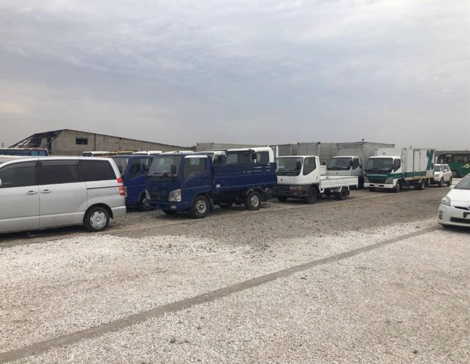Mitsubishi Fuso Canter 2-tonne flat-deck truck in a yard