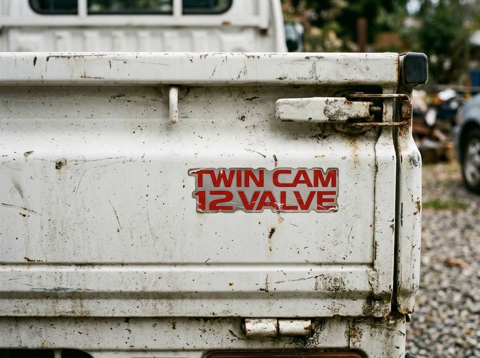 TWIN CAM 12 VALVE decal on the tailgate of a kei truck